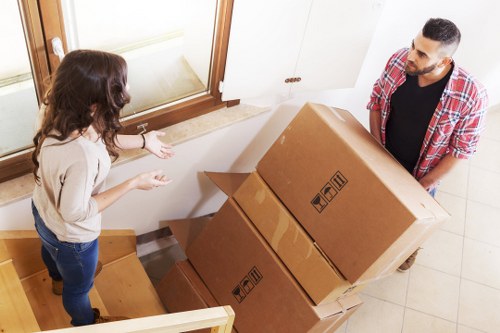 Movers handling office equipment and desks in Canary Wharf